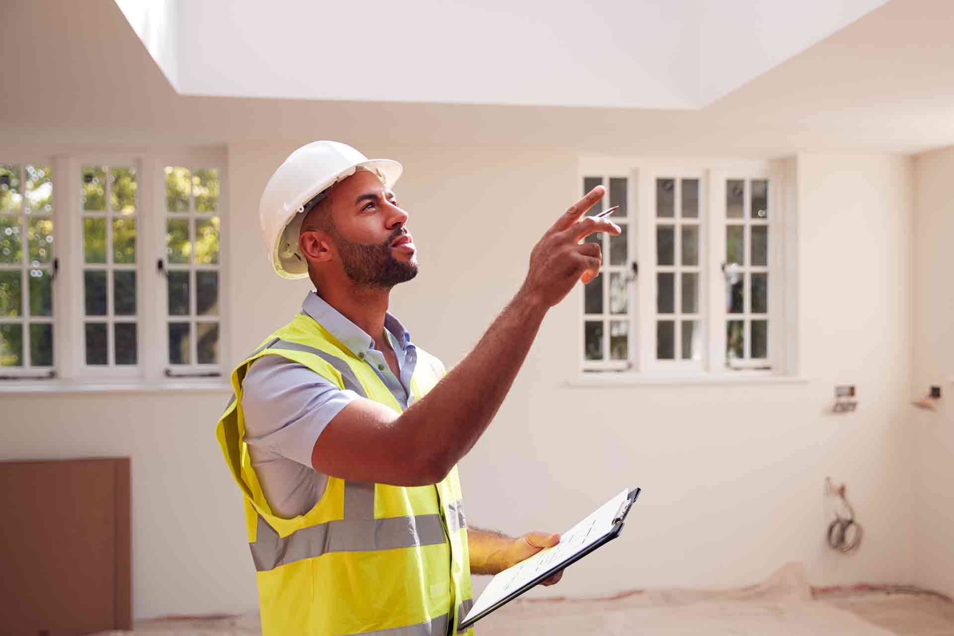 Third Party Wall Surveyors Milton Keynes reviewing plans between two parties during a dispute